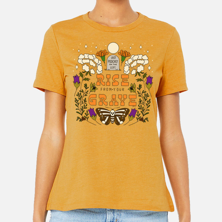 photo of female model flowers for your grave tee in mustard. last podcast on the left on gravestone at top. rise from your grave in orange below. moth with skull body below