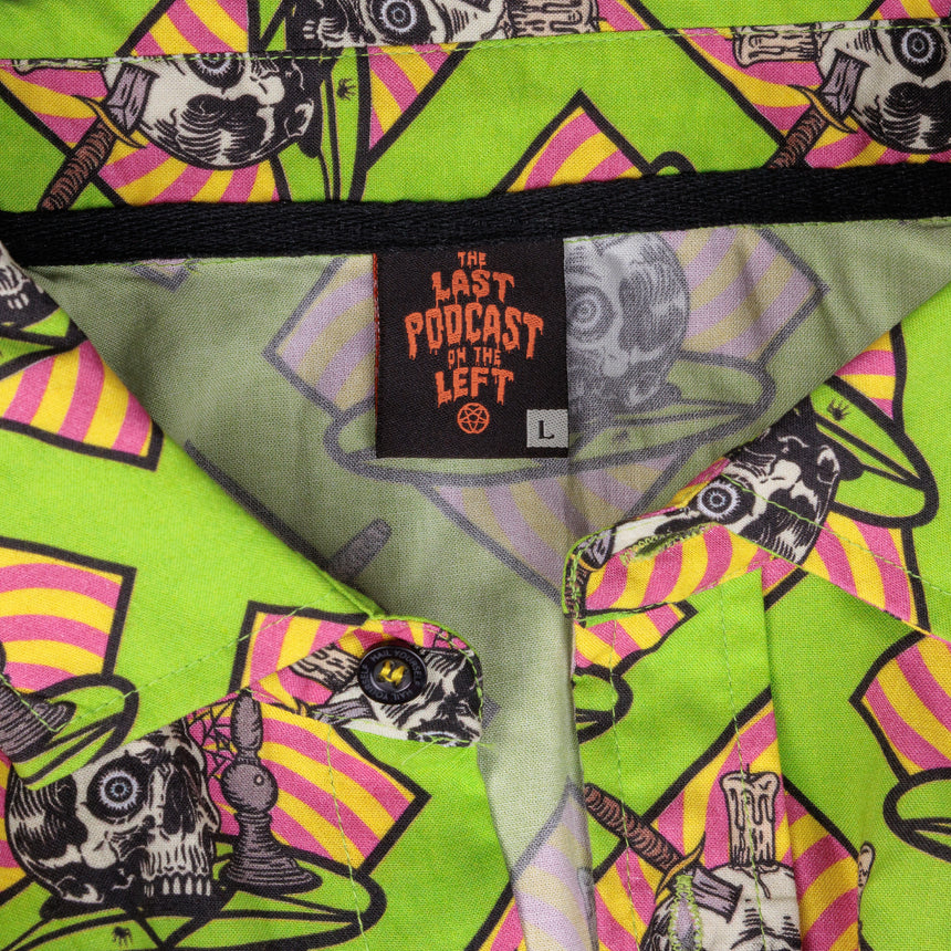 photo of female model wearing occult altar short sleeve buttondown. acid green background with skull on plate on orange background.