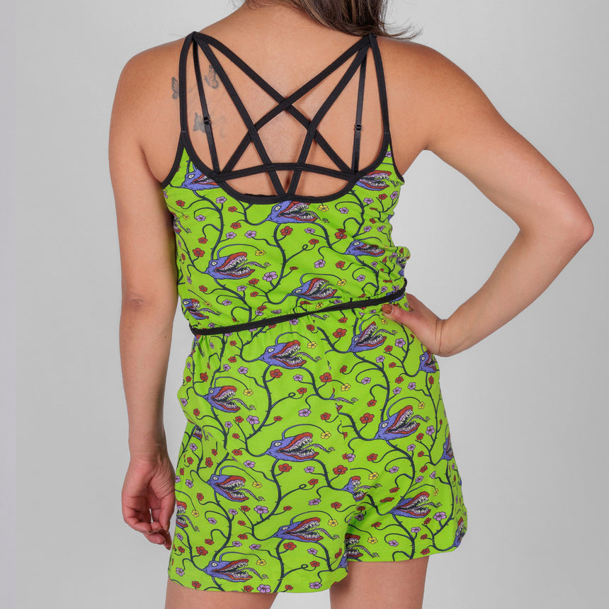 photo of female model wearing short romper with man eating plant pattern on acid green background