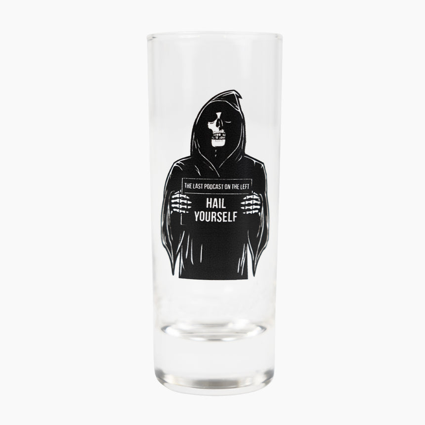 Shot glass with grim reaper on side holding sign with text "THE LAST PODCAST ON THE LEFT HAIL YOURSELF"