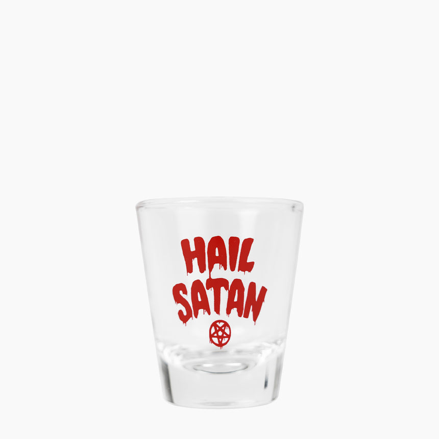Shot glass with red dripping text "Hail Satan" above red pentagram