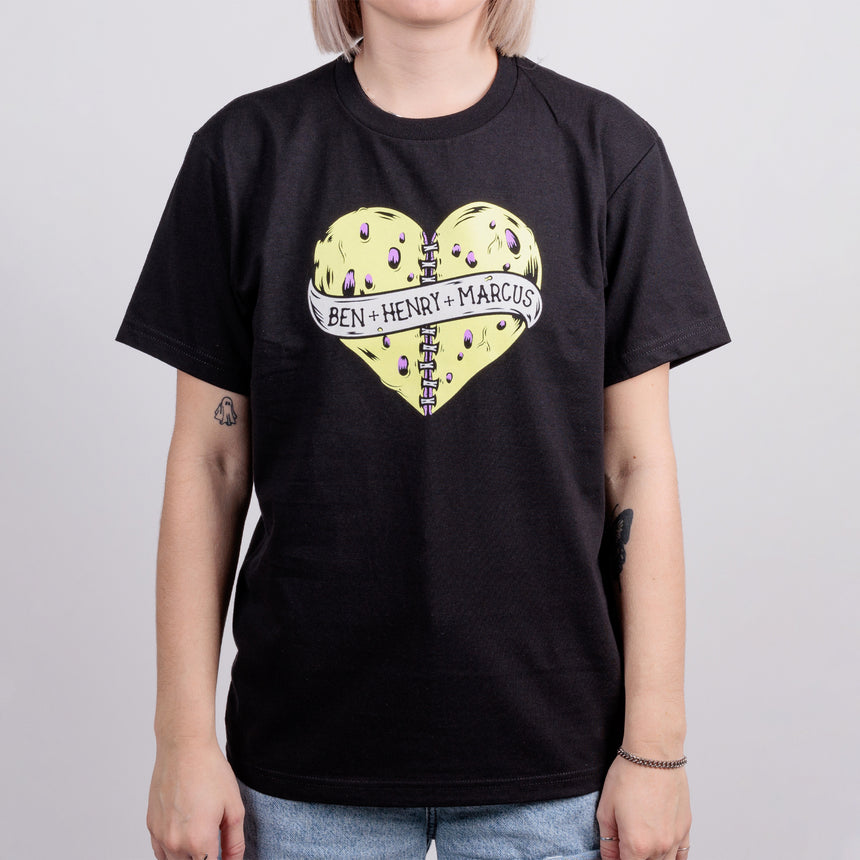 Women in black tee with poisoned heart graphic with text reading Ben + Henry + Marcus