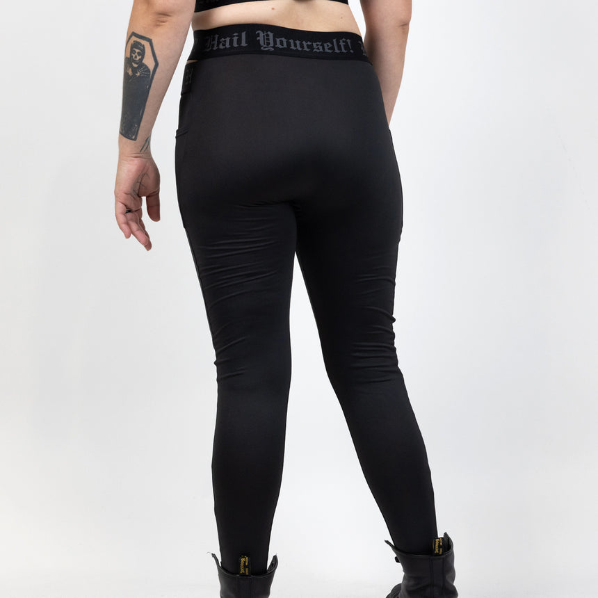 High waisted crossover legging with "Hail Yourself!" text on waistband