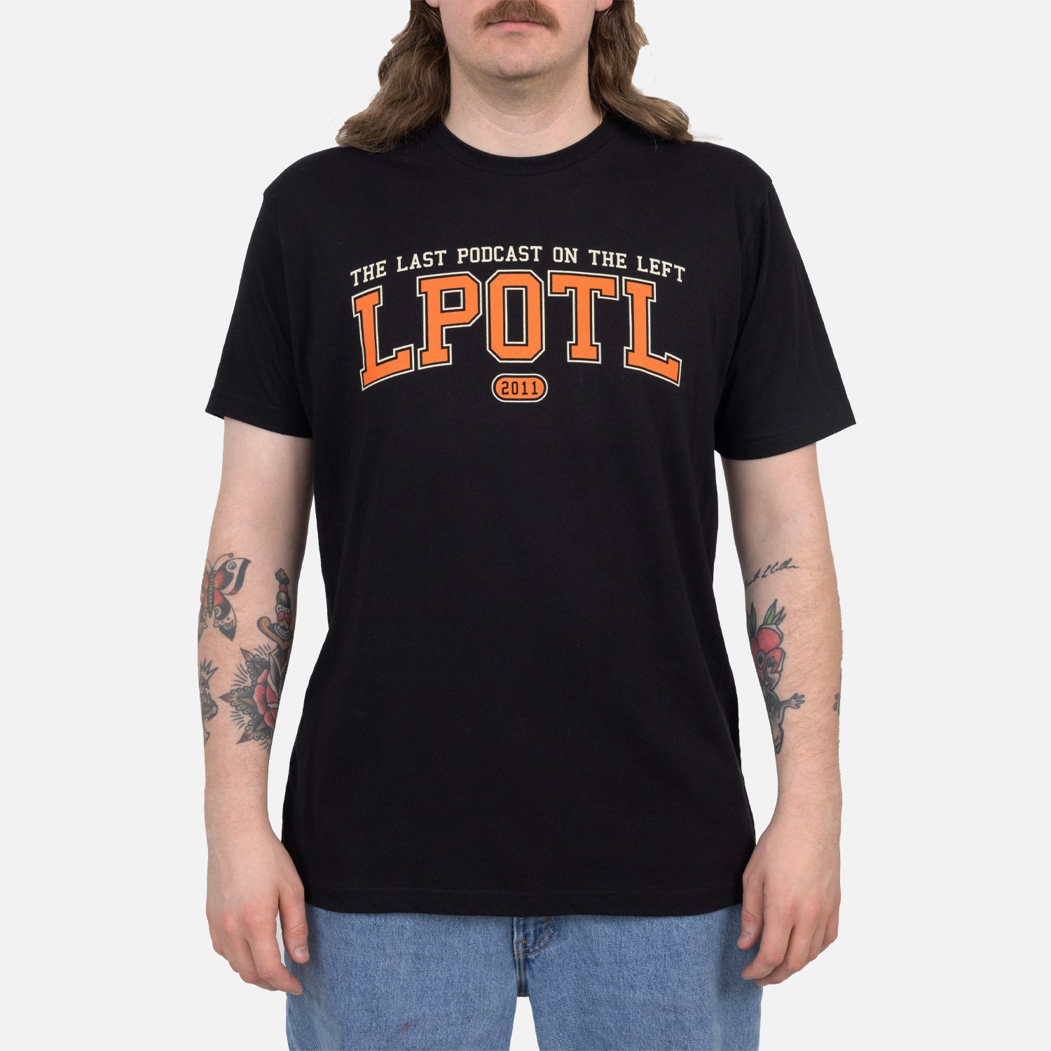 Male model wearing Black Collegiate style tee with text "THE LAST PODCAST ON THE LEFT LPOTL 2011"