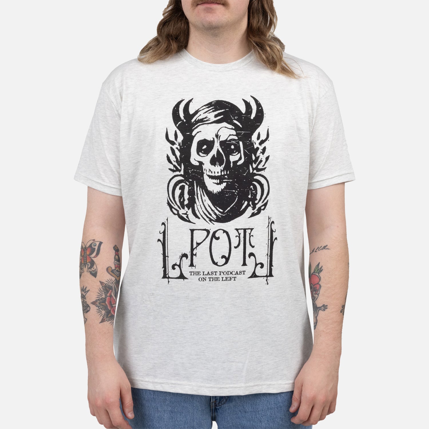 Male Model wearing Oatmeal tee with graphic of pagan skull with text "LPOTL THE LAST PODCAST ON THE LEFT"