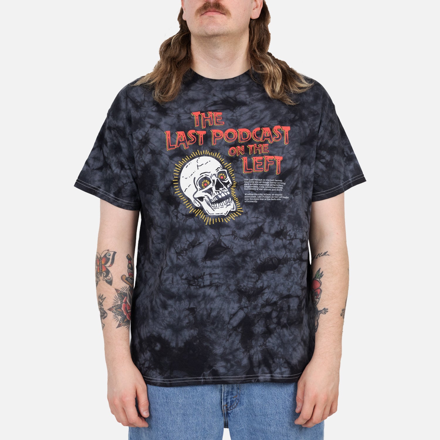 Male Model wearing Crystal black tee with graphic of a skull with text "THE LAST PODCAST ON THE LEFT"