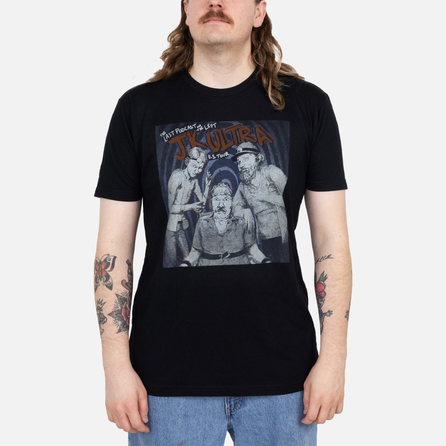 Male model wearing Black tee with grayscale graphic of the hoasts with text "THE LAST PODCAST ON THE LEFT JK ULTRA U.S. TOUR"