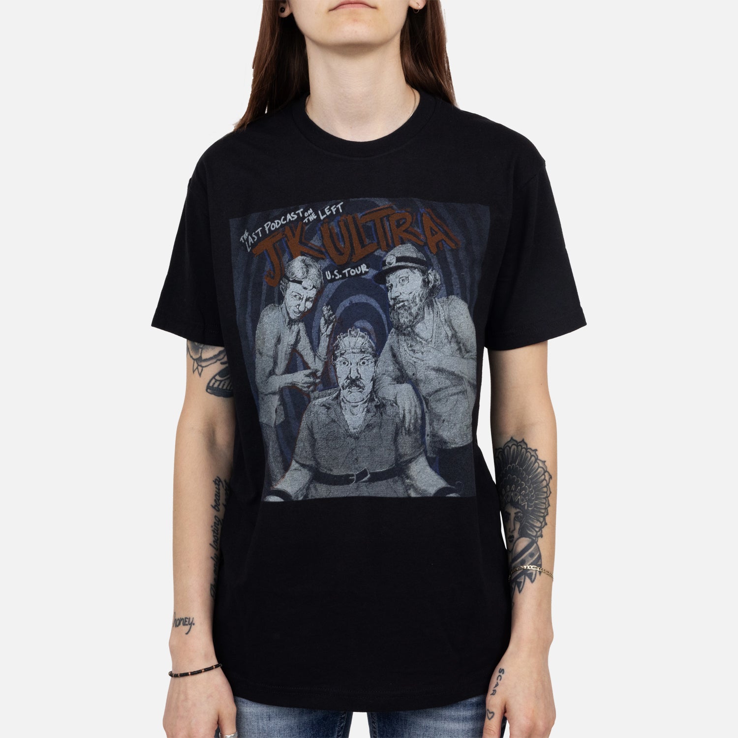 female model wearing Black tee with grayscale graphic of the hoasts with text "THE LAST PODCAST ON THE LEFT JK ULTRA U.S. TOUR"
