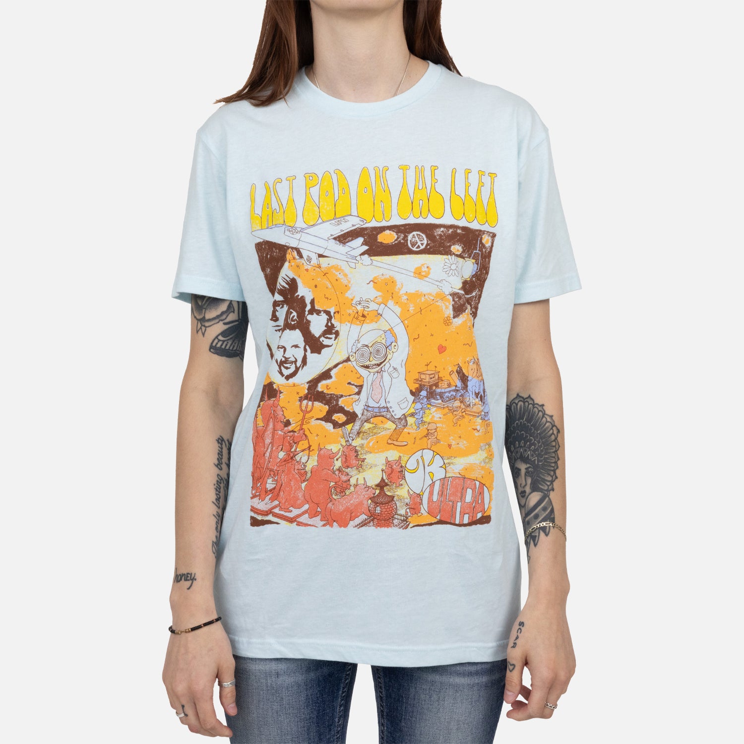 female model wearing Ice blue tee with mad scientist graphic with yellow text "LAST POD ON THE LEFT"
