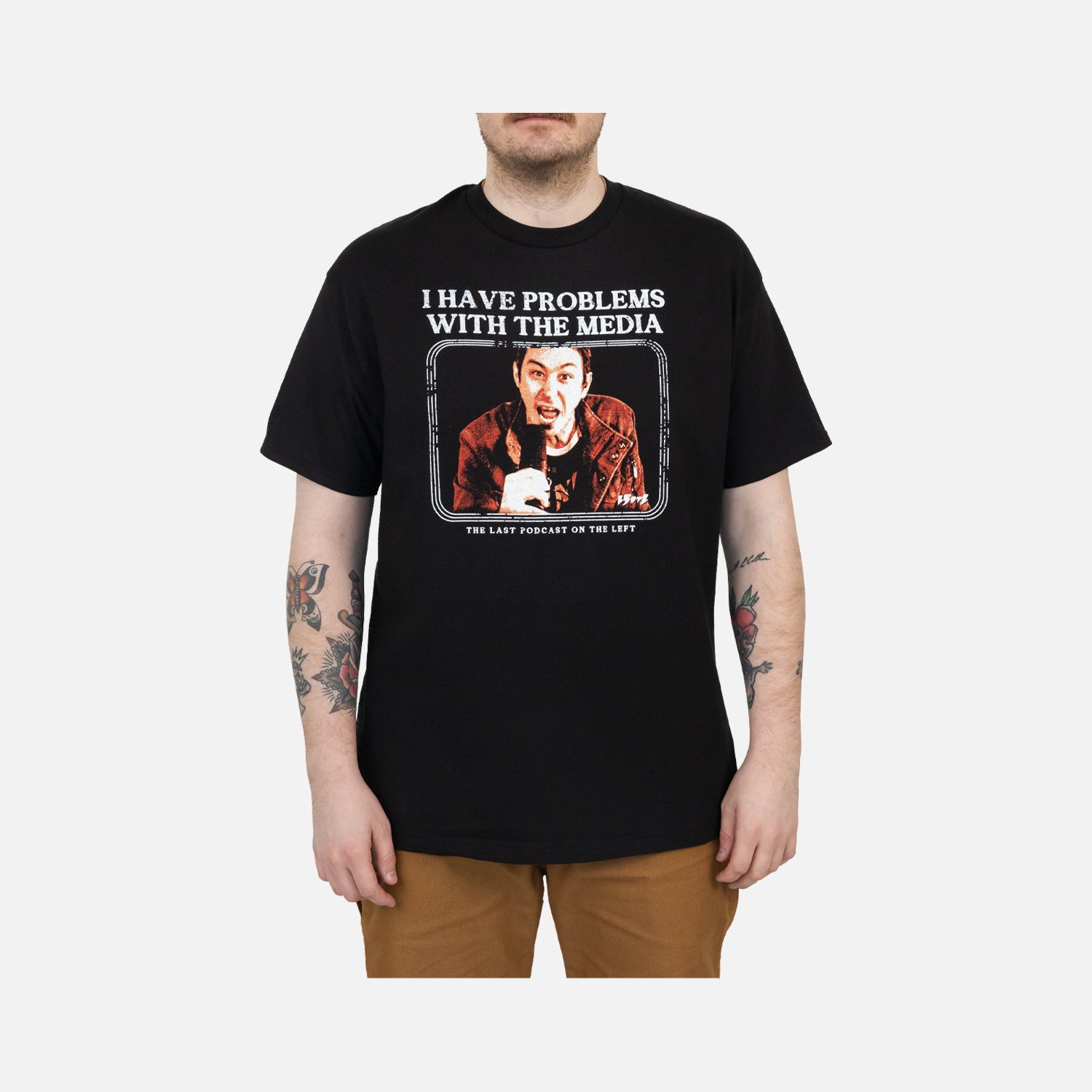 Black Tee on male model with graphic of Marcus with white text "I HAVE PROBLEMS WITH THE MEDIA THE LAST PODCAST ON THE LEFT"