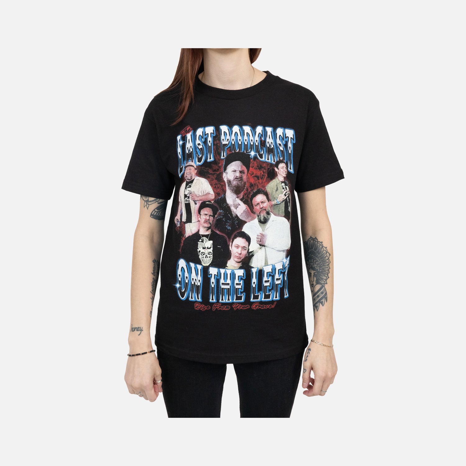 Black tee on female model with graphic of the hosts with blue and red text "THE LAST PODCAST ON THE LEFT RISE FROM YOUR GRAVE"