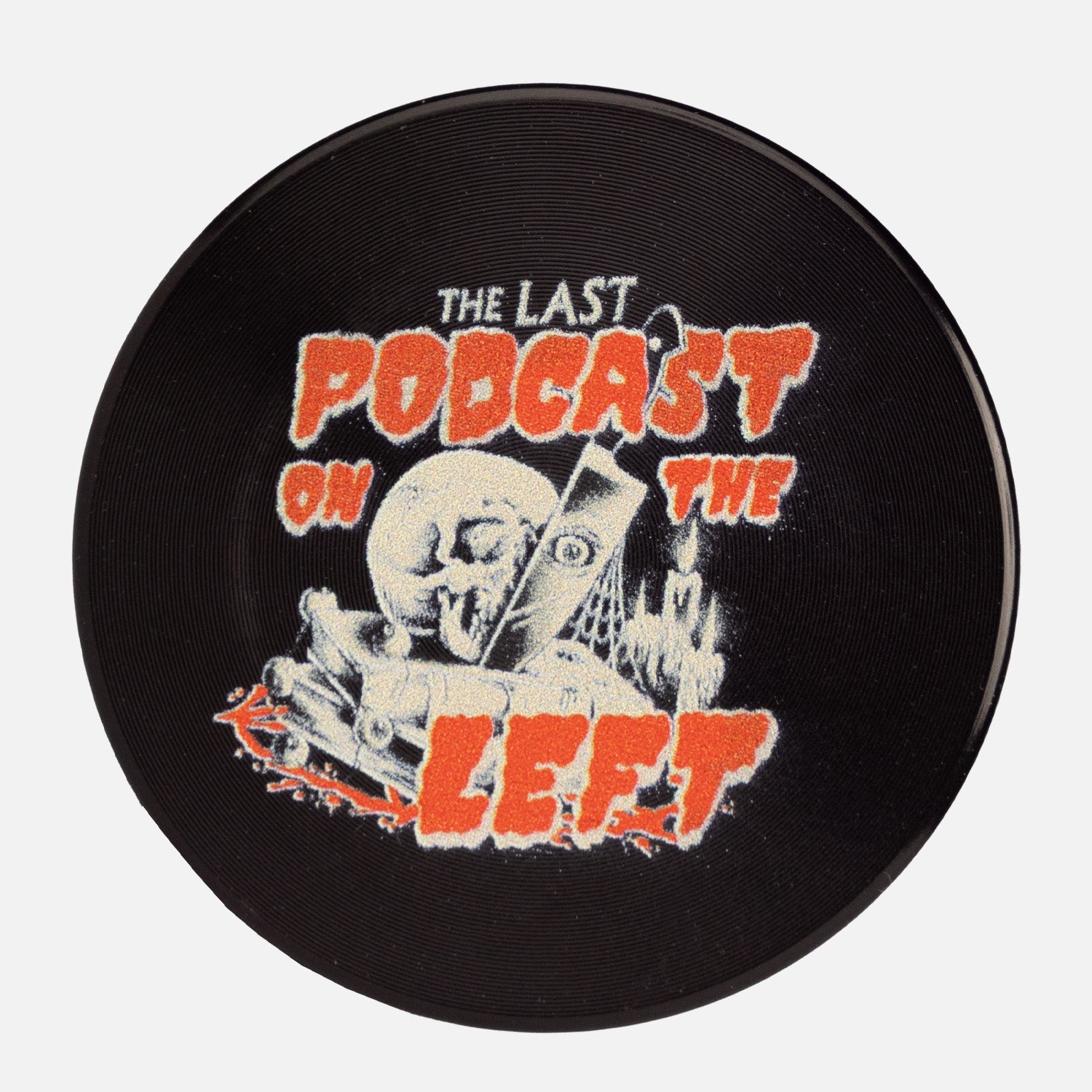 Top down view of Herb Grinder with "THE LAST PODCAST ON THE LEFT" logo on top