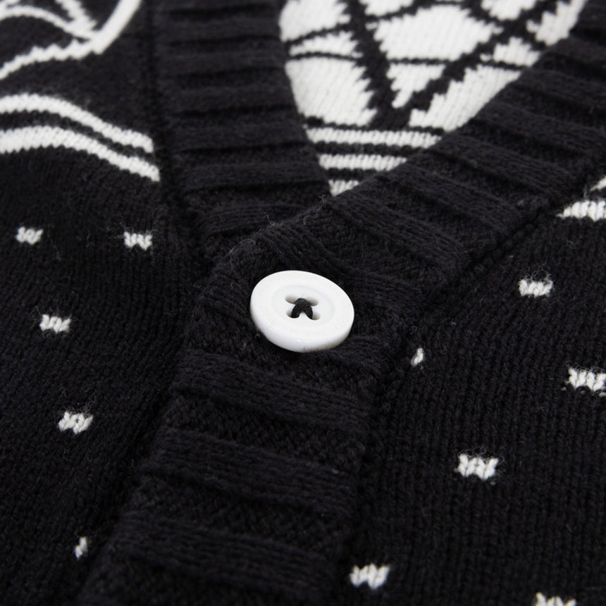 Black and white Holiday cardigan with skulls and pentagrams laid flat