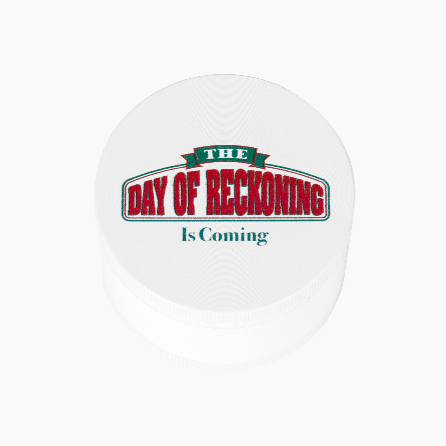 Herb grinder with text on front "THE DAY OF RECKONING Is Coming"