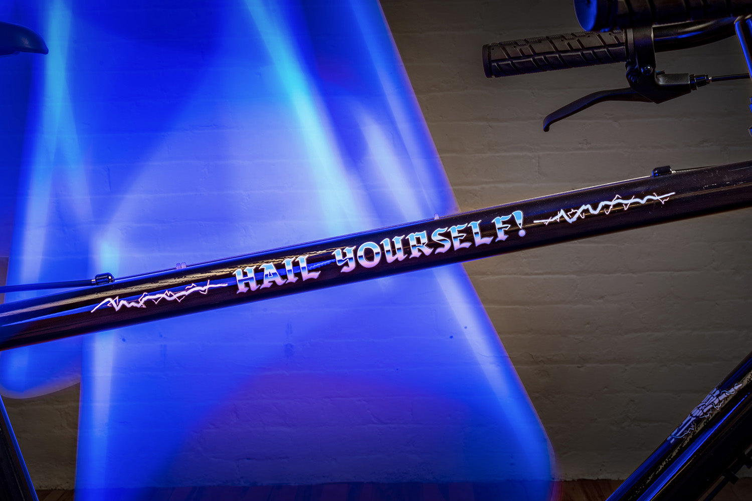 detail photo of top tube. hail yourself graphic text in blue and white