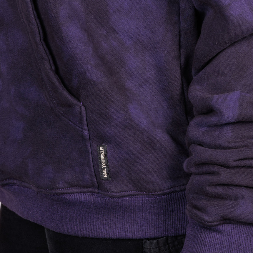 man in purple crumple dye hoodie with glow in the dark classic LPOTL logo on the front