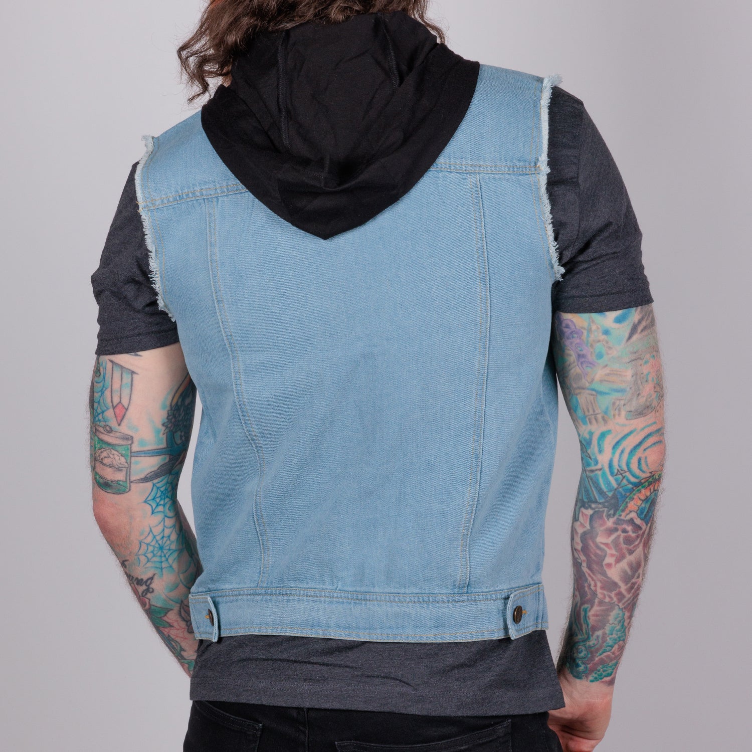 rear view photo of male model wearing hooded denim vest