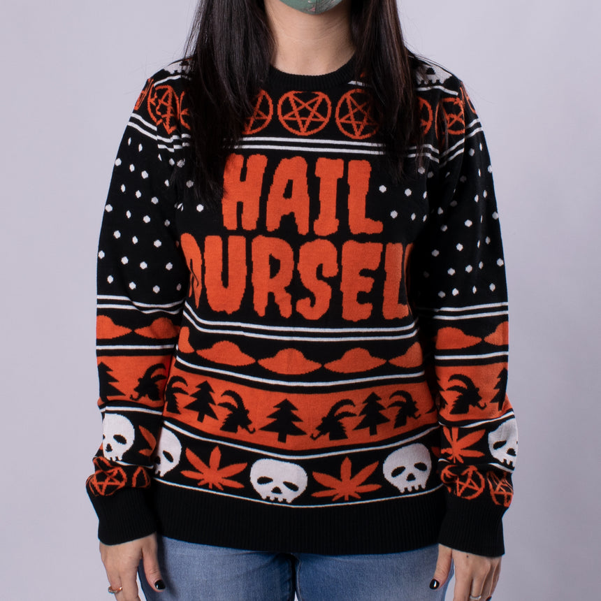 orange black and white yuletide holiday sweater with pentagram skull marijuana leaf  ufo goat head pattern on male model
