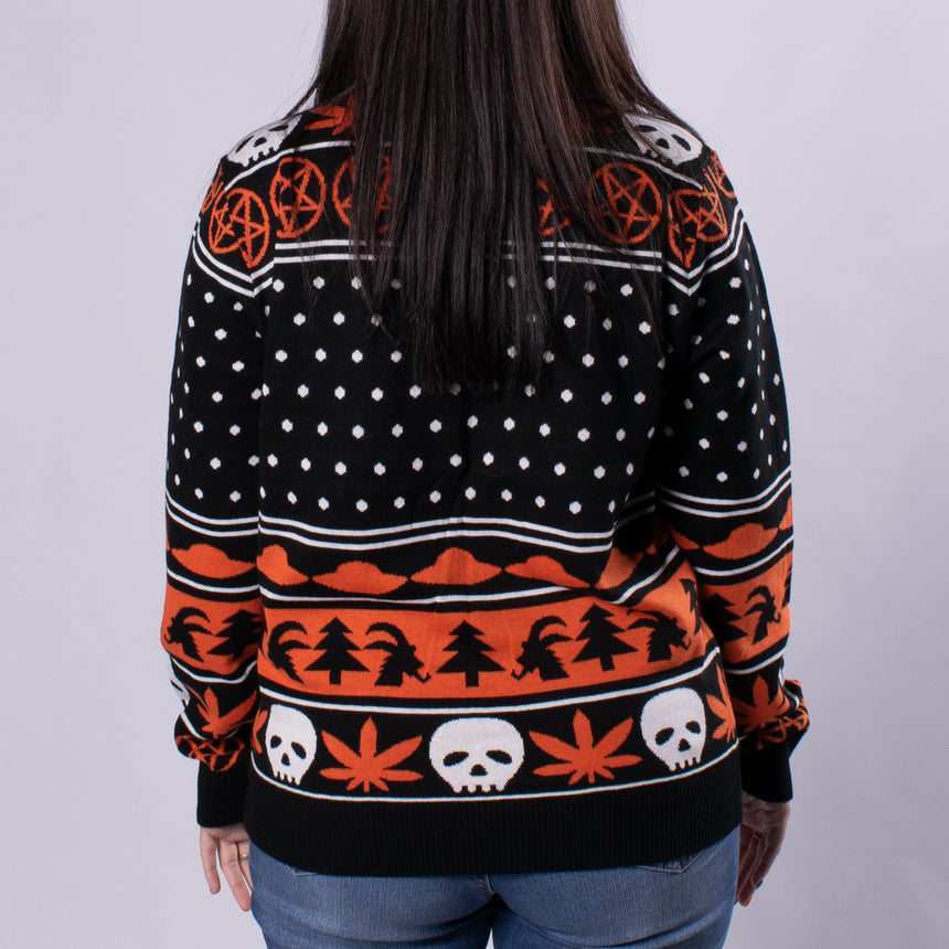 orange black and white yuletide holiday sweater with pentagram skull marijuana leaf  ufo goat head pattern on male model