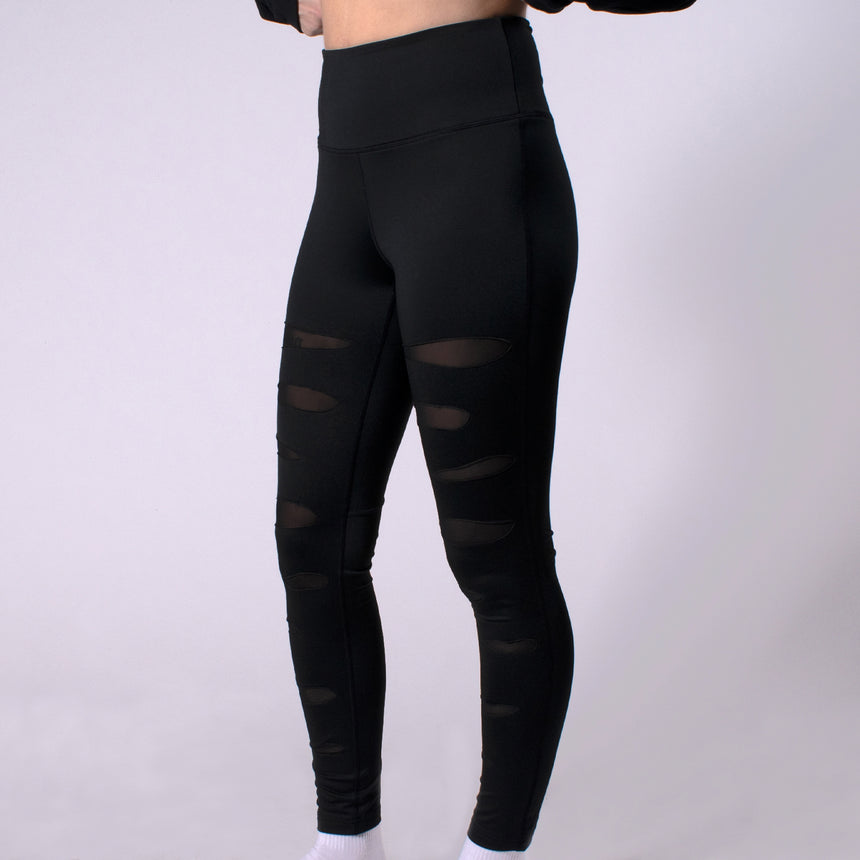 Woman in Mauled ripped black Compression leggings