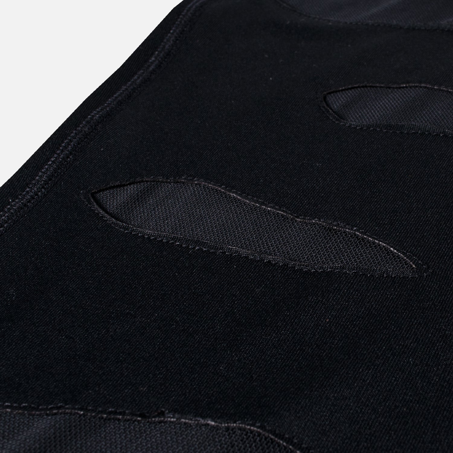 closeup of tears in Mauled compression leggings showing mesh under tears