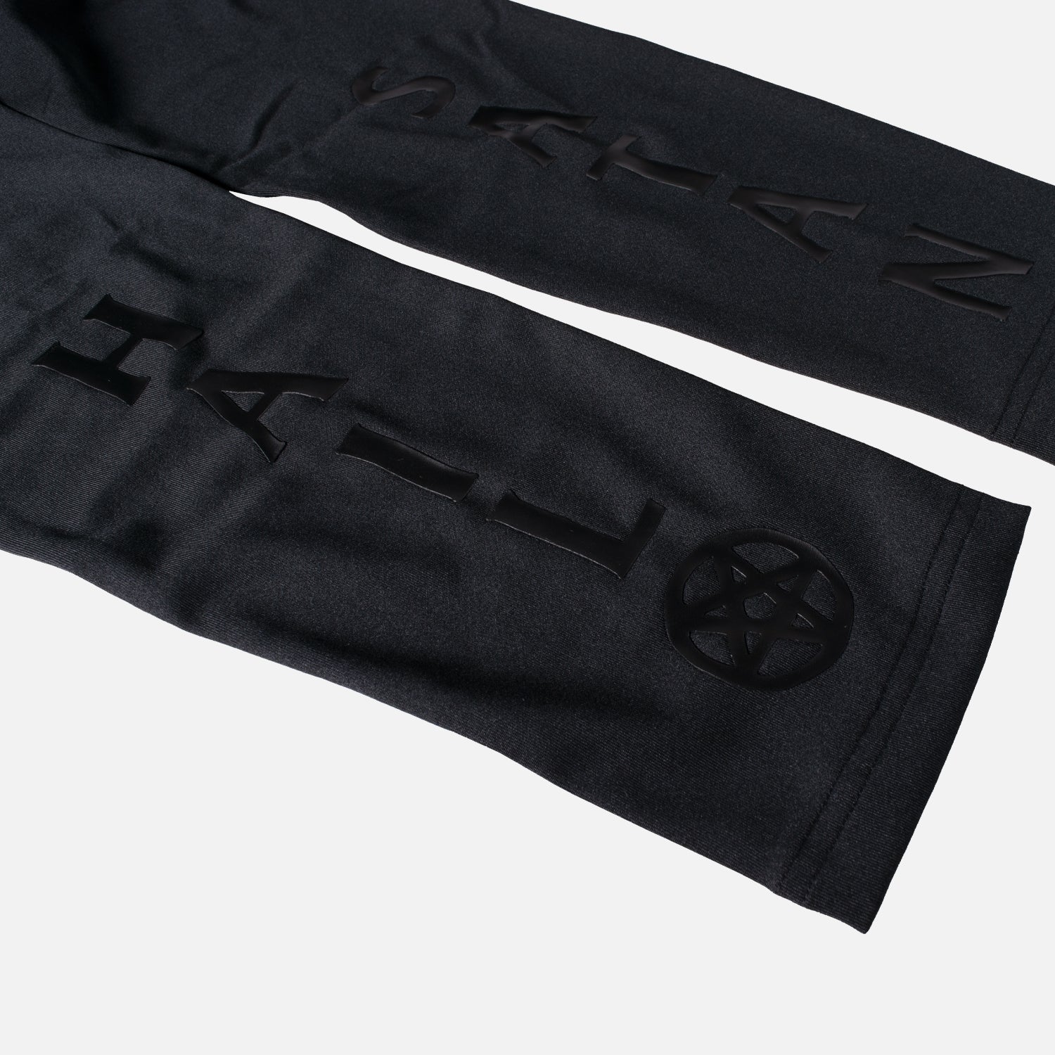 closeup of legs of mauled compression leggings showing Hail with a pentagram sign on left leg and SATAN on right leg