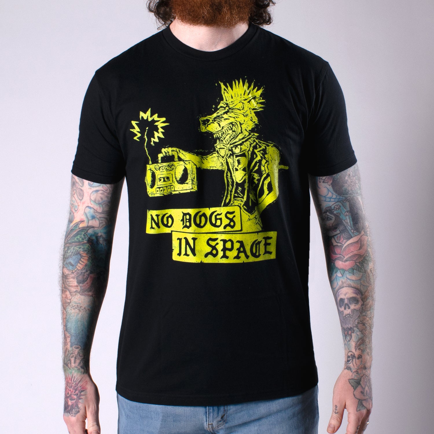 Man in black shirt with yellow rabid dog graphic with text NO DOGS IN SPACE
