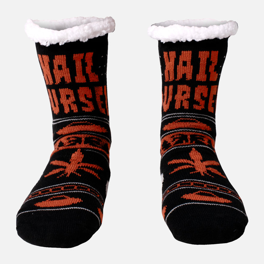 Side view of Black orange and white sock with sherpa lining with hail yourself skull and leaf iconography