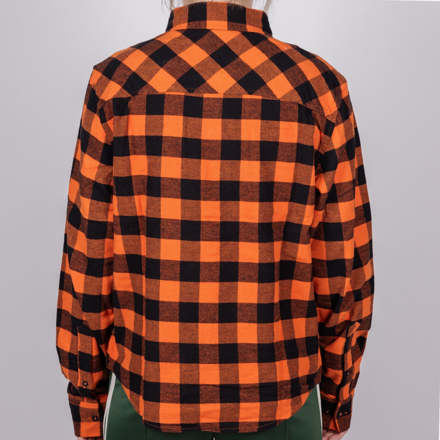 back of woman in orange black flannel buttondown