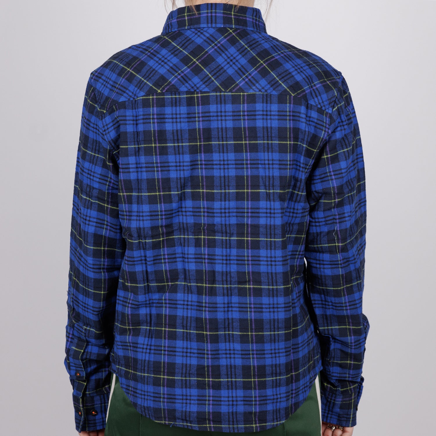 back of woman in blue plaid flannel buttondown