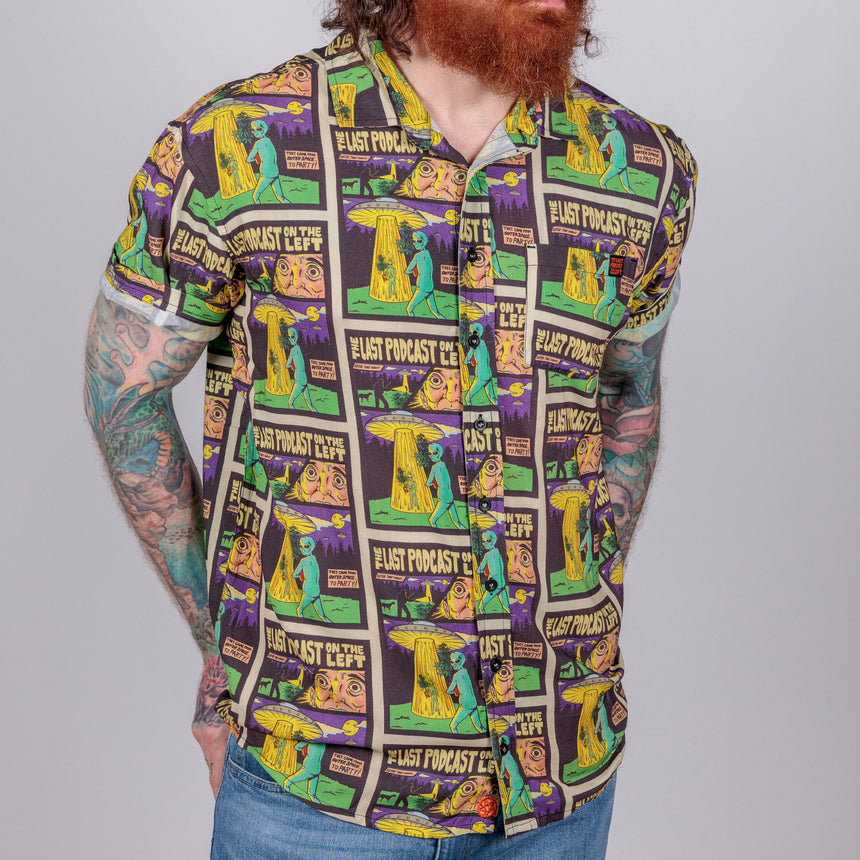 photo of male model wearing party time short sleeve button down. comic book background  with alien and spaceship 