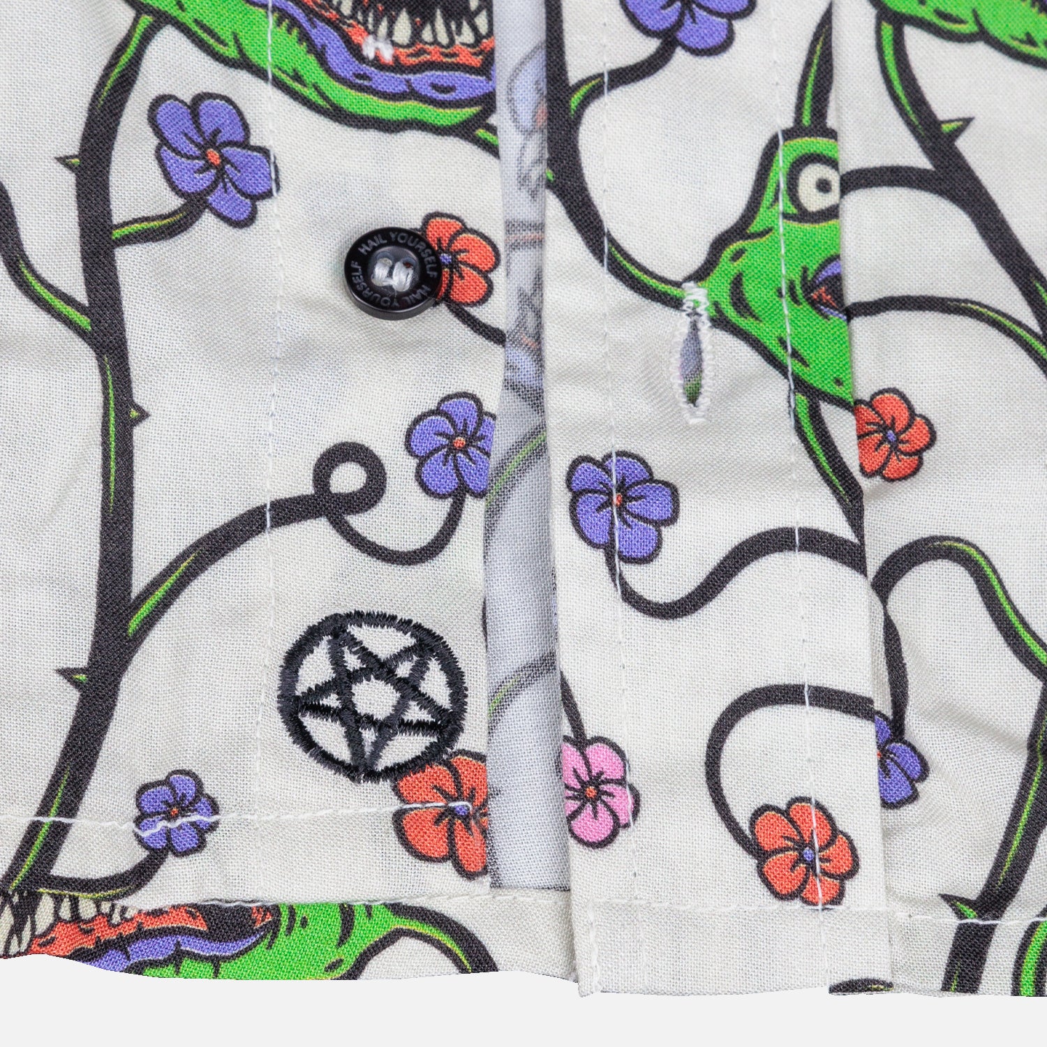 detail photo button. hail yourself on button. pentagram sewn on bottom near waist line