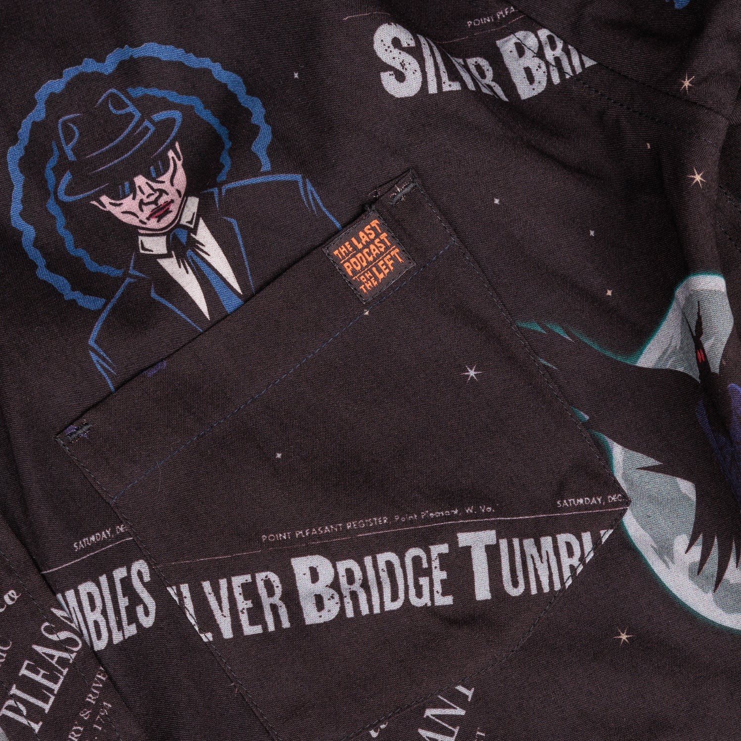 detail photo of pocket with tag on edge. black tag with last podcast on the left in orange