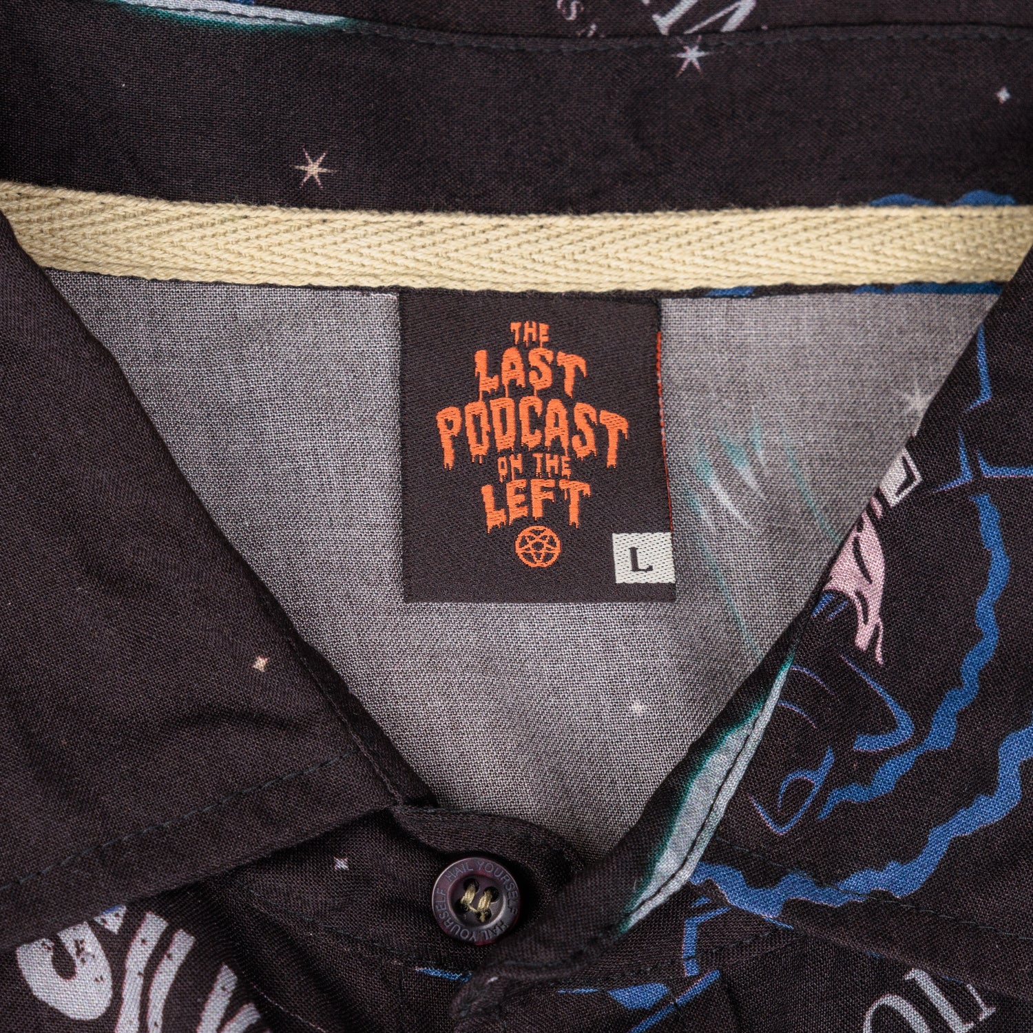 detail photo of neck tag in black . last podcast on the left in orange