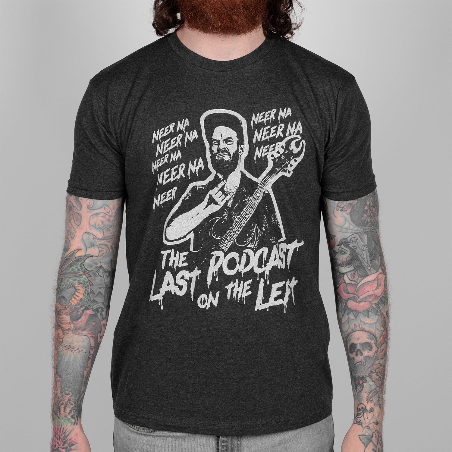 Man in Charcoal tee with white graphic of man playing guitar and text "NEER NA NEER NA NEERA THE LAST PODCAST ON THE LEFT"