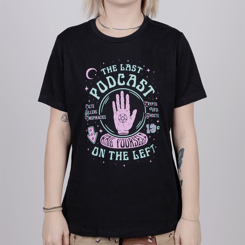 woman in black shirt with graphic of Hand with pentagram on palm surrounded by text "THE LAST PODCAST ON THE LEFT HAIL YOURSELF"