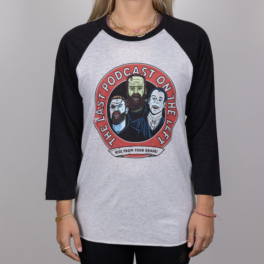 man in black and white vintage monster mash raglan tee with graphic of the hosts and text "THE LAST PODCAST ON THE LEFT RISE FROM YOUR GRAVE!"