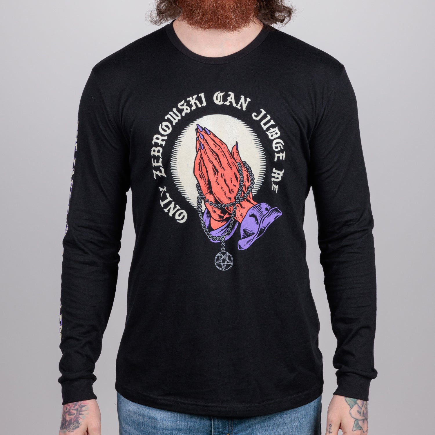 Man in black shirt with praying hands graphic surrounded by text "ONLY ZEBROWSKI CAN JUDGE ME"