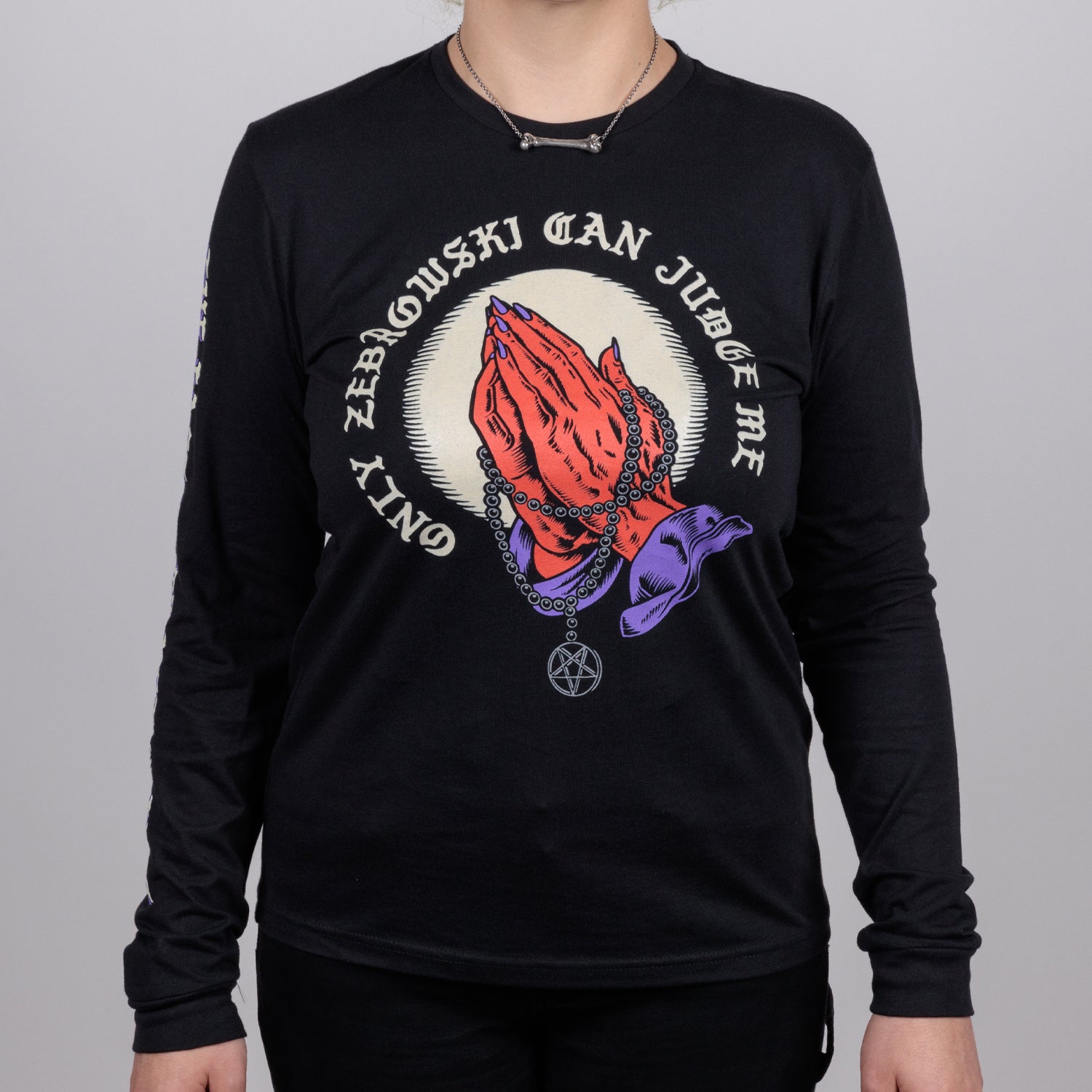 Woman in black shirt with praying hands graphic surrounded by text "ONLY ZEBROWSKI CAN JUDGE ME"